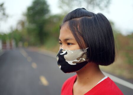 Concepts in preventing the outbreak of the Covid 19 virus Girls wear hygiene faces to prevent outbreaks.の写真素材