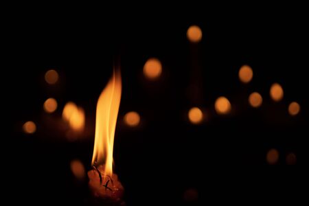 candles and lights  on a black background with boken lights.
