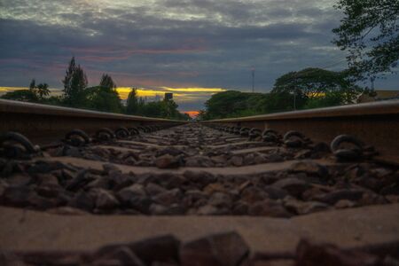 Railway tracks from one city to another in Thailand in the evening of the sunset.の写真素材