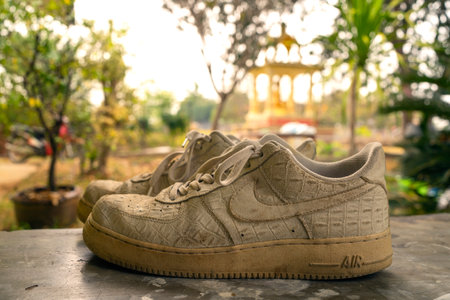 February 9, 2021 Buriram Thailand Close-up Nike Air Foce 1 White is a white leather shoes made of crocodile skin on the floor.のeditorial素材