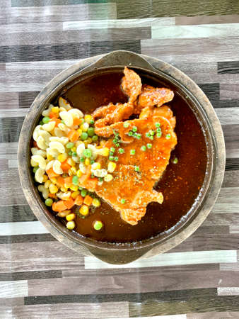 Ready pork steak is served hot on a plate, put on a plate to prevent heat.の写真素材