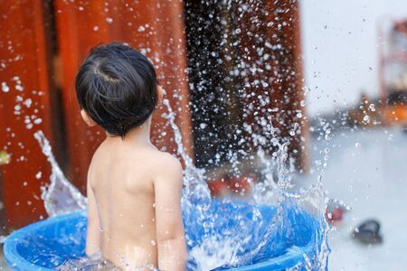 Children play in the water splashingの写真素材