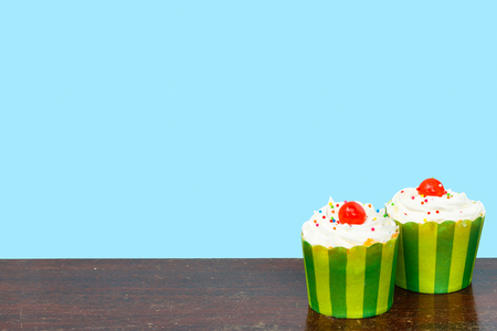 Colorful cupcakes on a wooden backgroundの写真素材