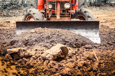 The tractor working on the large field blurの写真素材