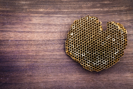 Honeycomb on a wooden backgroundの写真素材