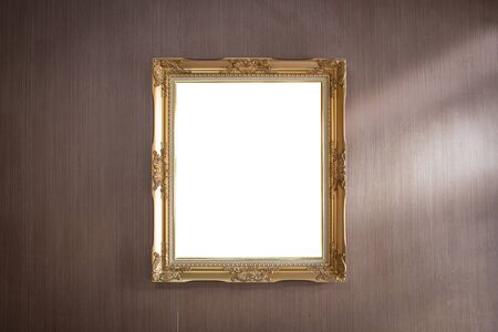 Gold frame on dark wood wall detail