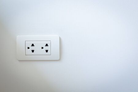 Electrical plugs on the white wall detailの写真素材