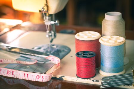 Closeup thread with a cloth strap on a sewing machine detail blur