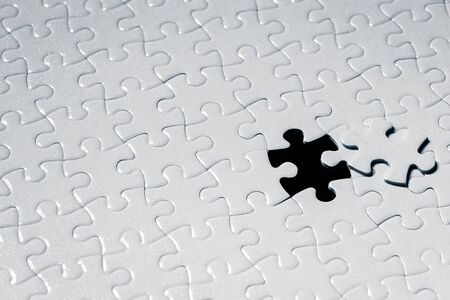 Close up piece of white jigsaw puzzle detail object