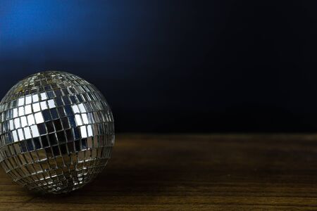 Disco ball on dark wooden floor background detail object artの写真素材