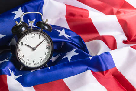 Retro alarm clock on National flag of America background detail artの写真素材