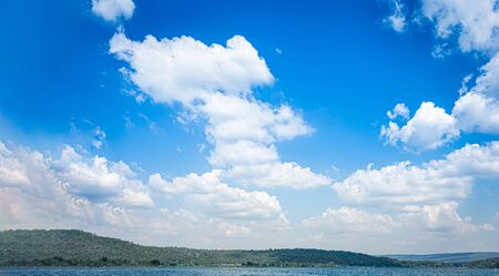 Blue sky and white clouds on the mountain and lake water detail nature backgroundの写真素材