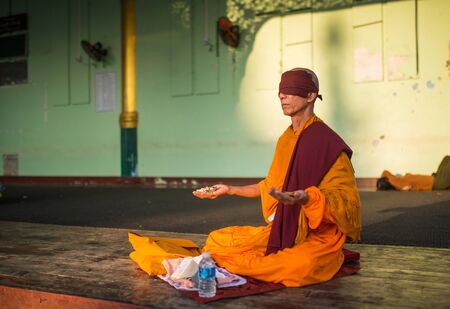 Yangon, Myanmar -  February 23: Unidentified Monk Praying in Yangon, Myanmar 23, 2017のeditorial素材