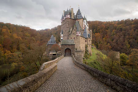 Burg Eltz castle in autumn colors with forests, Germany