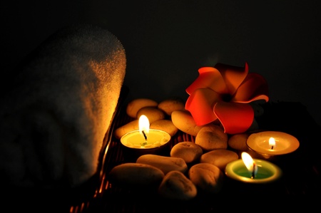 Three candles and one towels on bamboo matの写真素材