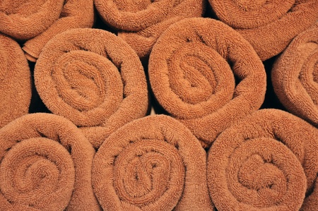 A lot of rolled brown towels  full frame.の写真素材