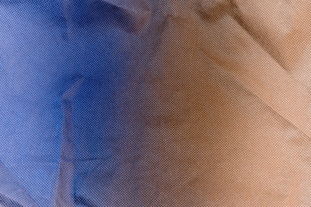 Black cloth with hole texture and contrast blue-orange light