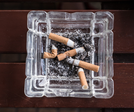 cigarette stub with ashes in the ashtray. Smoke and cancer.の写真素材