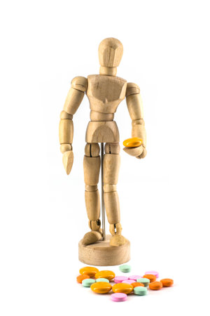 wood figure sick with  medicine isolate on white backgroundの写真素材
