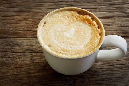 Coffee cup top view on old woodenの写真素材