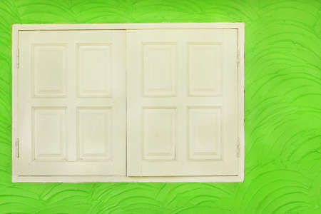 white wooden window on cement concrete wall with vintage style pattern for background and design art work.の写真素材