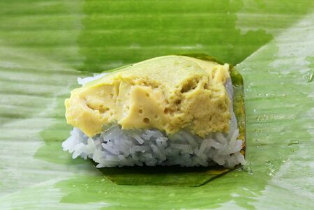 Thai dessert, Sticky rice and egg custard wrapped with banana leaf.