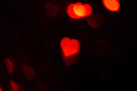 Red hearts bokeh, abstract of blurred bright light for valentines day, defocused background.の写真素材