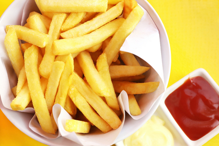 French fries with ketchup and mayonnaise, top view of potato fry.