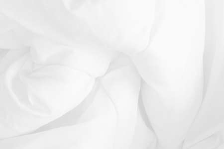 Close up top view of white bedding sheet and wrinkle messy blanket in bedroom after wake up in the morning.の写真素材