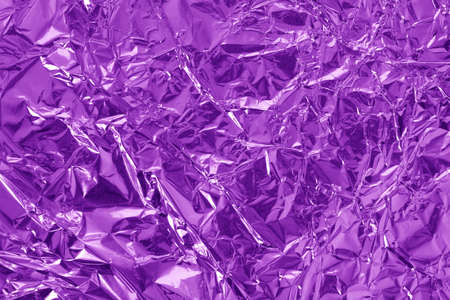 Purple metallic foil shiny texture, wrinkled wrapping paper for background and design art work.の写真素材