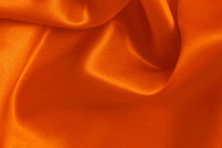 Orange fabric cloth texture for background and design art work, beautiful crumpled pattern of silk or linen.の写真素材