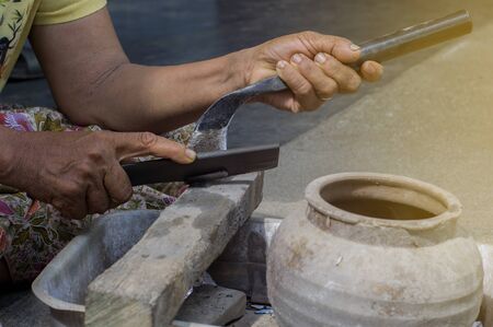 Rubber planters are cleaning and secretly cut the rubber knife for tapping rubber with selective...