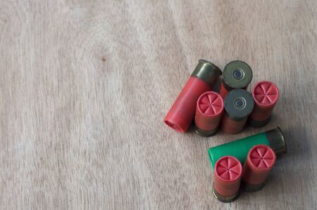 Close-up of ammo on wood floor with selective focus.