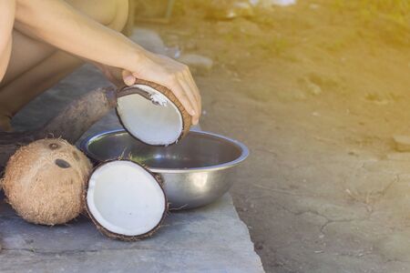 Humans are scraping coconut to make coconut milk. to be used as an ingredient in the food with the selected focus.の写真素材