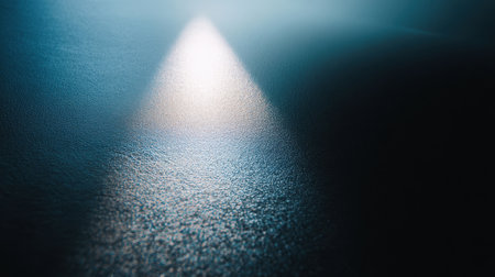 This captivating image features a soft blue light beam cutting through darkness, casting a serene glow on a textured surface, ideal for creating atmospheric backgrounds.の素材