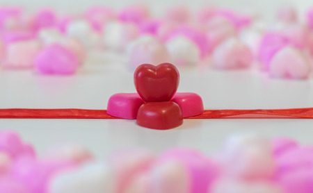 Red Heart shaped chocolates on ribbon