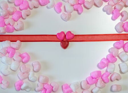 Red Heart shaped chocolates on ribbon