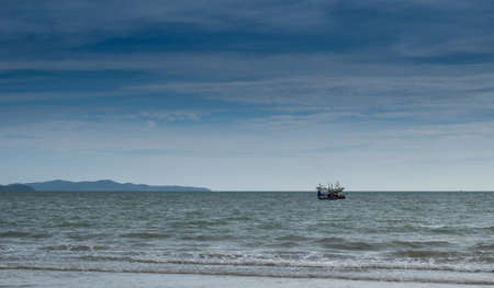 Small boat floating on the sea and the beautiful blue sky