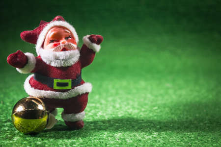 Santa Claus with gold ball on green background.の写真素材