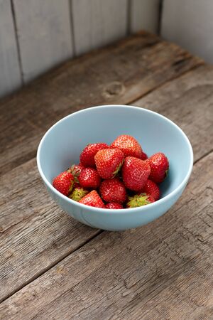 Strawberry in a blue ceramic bowlの写真素材