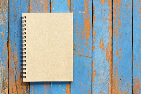 Brown notebook on wooden backgroundの写真素材