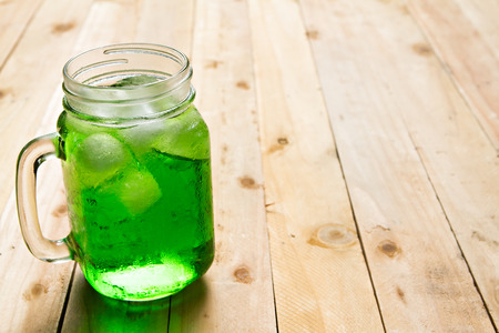 Jar of sweet drink on wooden table.の写真素材