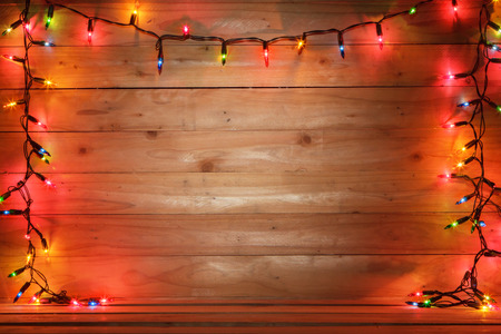 Christmas light and wooden background.