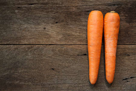 Fresh carrots on wooden background.の写真素材