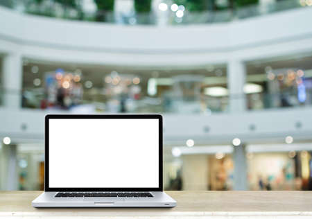 Laptop computer on table with de focused of departmentstore.の写真素材