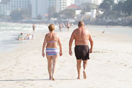 People walking and have activities on the beach. Lens blur.の写真素材