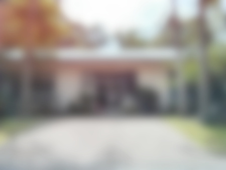 Abstract blurry background of cottage surround by treeの写真素材