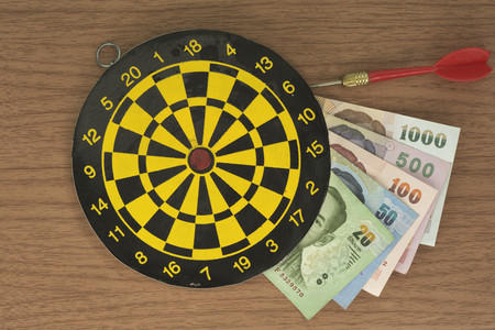 Dart, target, and Money on tableの写真素材