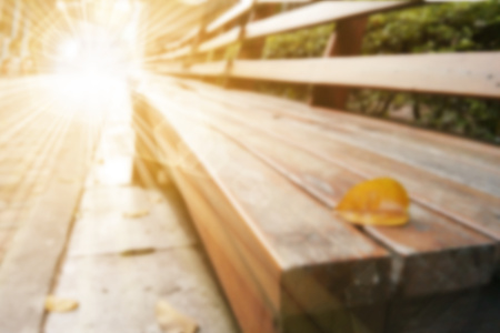 Abstract blurry warm background with a leaf over chair and bright sun star at apex line of sightの写真素材