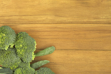 Broccoli on golden teak wood backgroundの写真素材